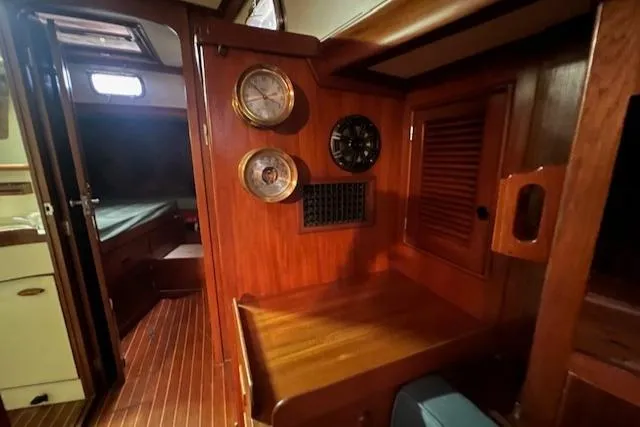 Slide: The Image of Interior of 1984 Mason 43 Cutter sailboat with wooden cabinetry and nautical instruments. - 18