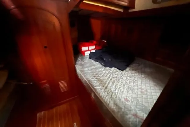 Slide: The Image of Cozy cabin interior of 1984 Mason 43 Cutter with wooden finish and bed. - 19