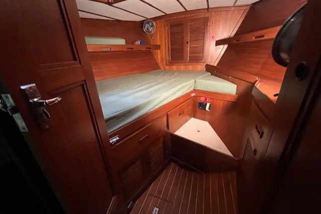 Slide: The Image of Cozy cabin interior of 1984 Mason 43 Cutter sailboat with wooden furnishings. - 20