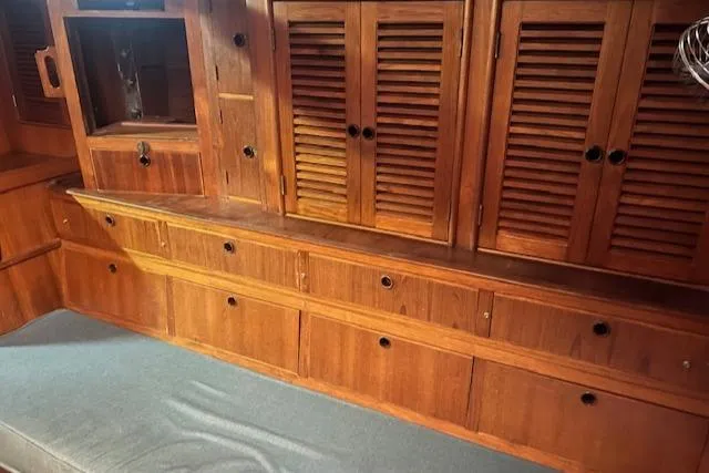 Slide: The Image of Interior of 1984 Mason 43 Cutter with wooden cabinets and storage drawers. - 21