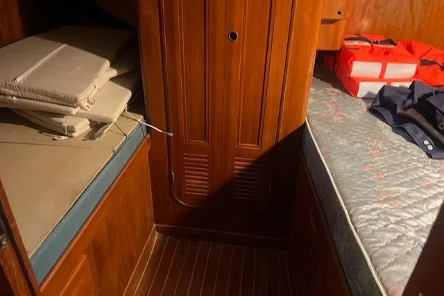 Slide: The Image of Interior of 1984 Mason 43 Cutter with wooden cabinetry and bedding. - 25