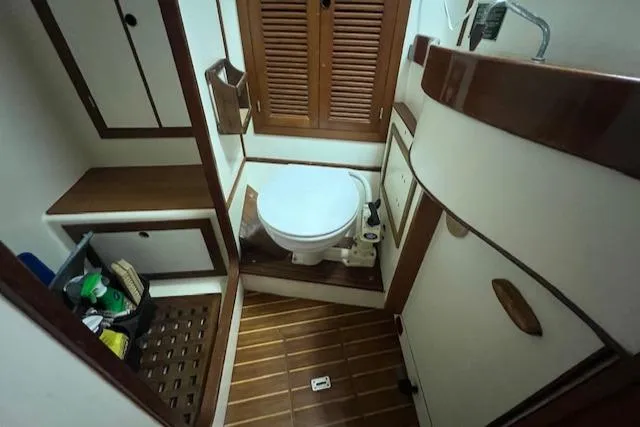 Slide: The Image of 1984 Mason 43 Cutter yacht bathroom with wooden accents and storage cabinets. - 30