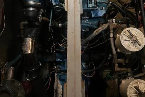 Slide: The Image of Engine compartment of a 1984 Mason 43 Cutter sailboat, showcasing mechanical components and wiring. - 31