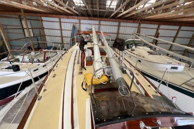 Slide: The Image of 1984 Mason 43 Cutter sailboat stored in a wooden boathouse. - 34