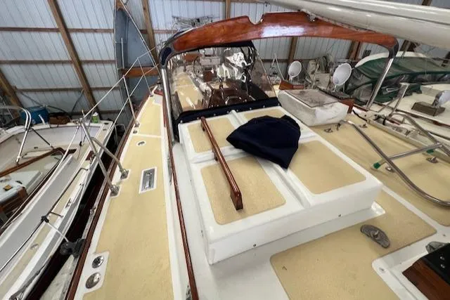 Slide: The Image of 1984 Mason 43 Cutter sailboat deck in storage, featuring wooden accents and spacious layout. - 39