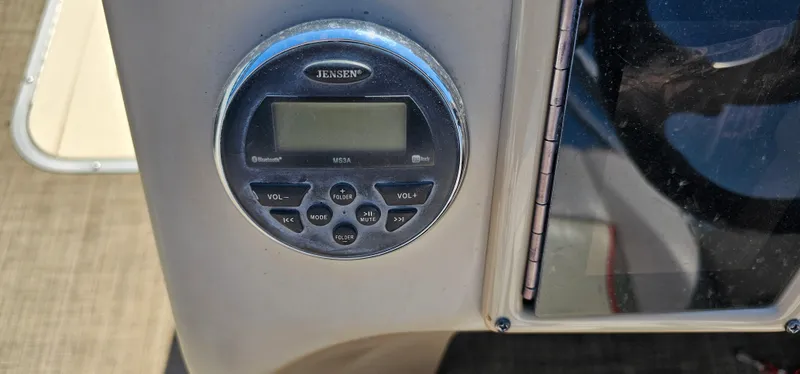 Slide: The Image of Jensen stereo system on 2017 G3 Sun Catcher V322C boat dashboard. - 10