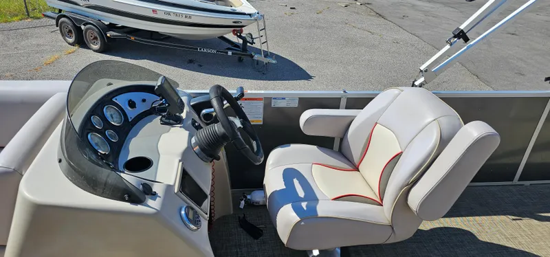 Slide: The Image of 2017 G3 Sun Catcher V322C boat interior with steering console and captain's chair. - 7