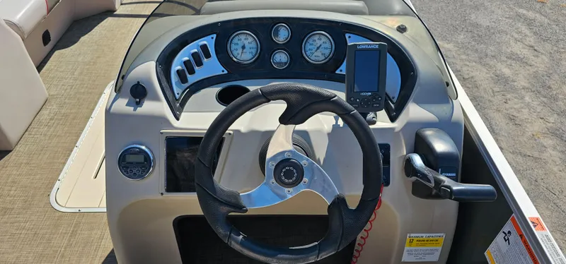 Slide: The Image of 2017 G3 Sun Catcher V322C boat dashboard with steering wheel and gauges. - 9