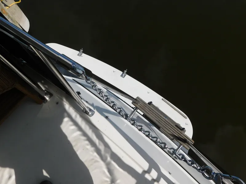 Slide: The Image of 1985 Carver 3607 Aft Cabin boat deck with railing and chain detail. - 12