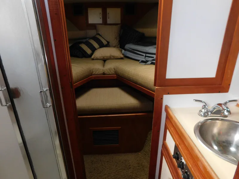 Slide: The Image of 1985 Carver 3607 Aft Cabin interior with cozy bed and compact sink area. - 19