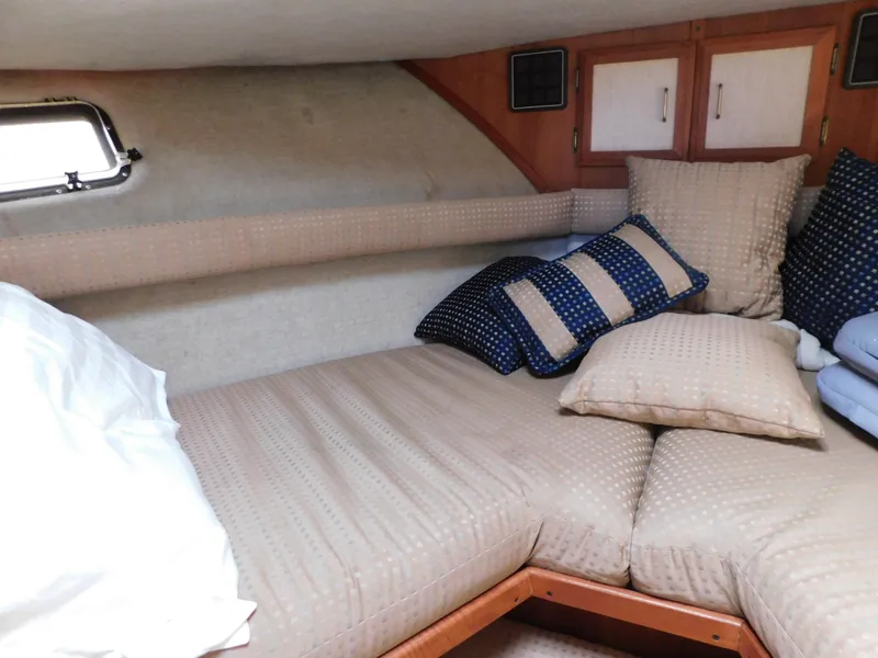Slide: The Image of 1985 Carver 3607 Aft Cabin interior with cozy bed and patterned pillows. - 22