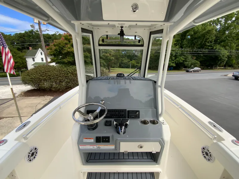 Slide: The Image of 2025 Cobia 265 Center Console Open boat interior with steering wheel and controls. - 11