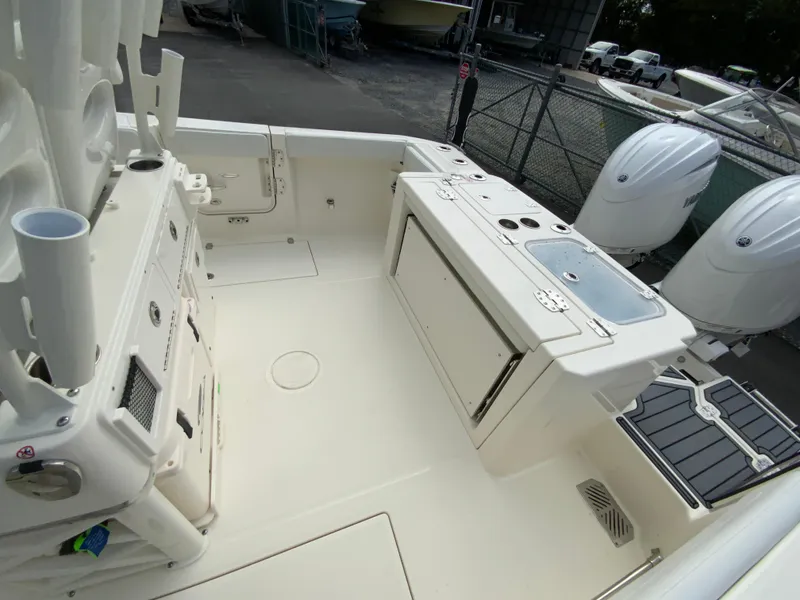 Slide: The Image of 2025 Cobia 265 Center Console Open boat deck with storage and dual engines. - 14