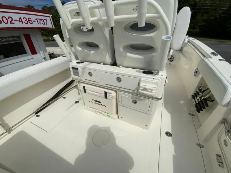Slide: The Image of 2025 Cobia 265 Center Console Open boat interior with storage and seating. - 19