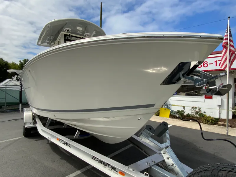 Slide: The Image of 2025 Cobia 265 Center Console Open boat on trailer, outdoor display. - 2