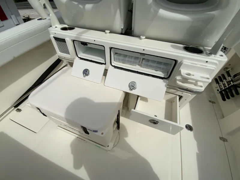 Slide: The Image of 2025 Cobia 265 Center Console Open boat interior with storage compartments and cooler. - 20
