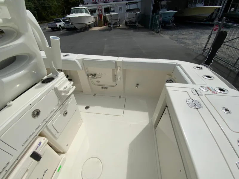 Slide: The Image of 2025 Cobia 265 Center Console Open boat interior, featuring spacious deck and storage compartments. - 21