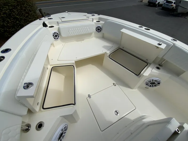 Slide: The Image of 2025 Cobia 265 Center Console Open boat interior with storage compartments and seating. - 25