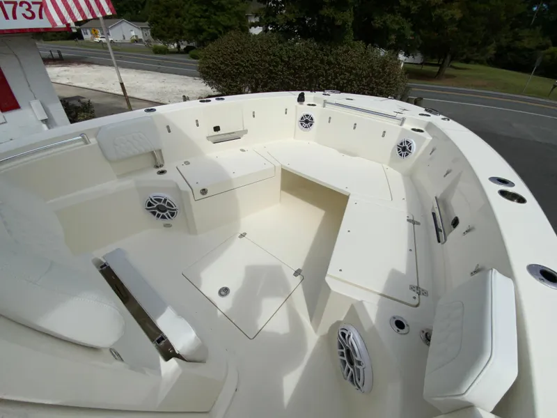 Slide: The Image of 2025 Cobia 265 Center Console Open boat interior with seating and storage. - 26