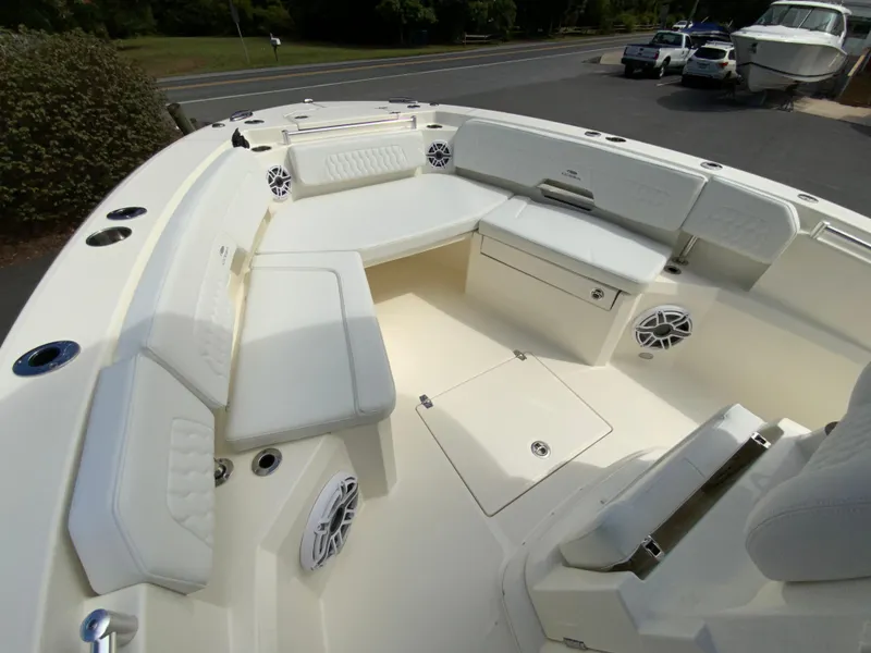Slide: The Image of 2025 Cobia 265 Center Console Open boat interior with white seating and storage. - 27