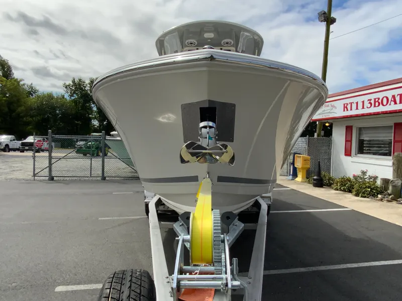 Slide: The Image of 2025 Cobia 265 Center Console Open boat on trailer in parking lot. - 3
