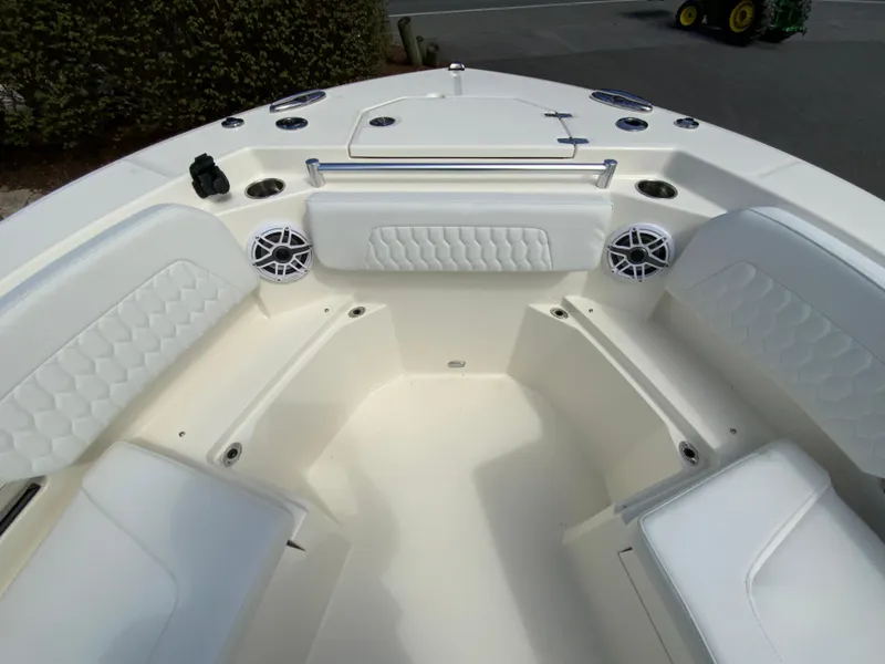 Slide: The Image of 2025 Cobia 265 Center Console Open boat interior with cushioned seating and speakers. - 31
