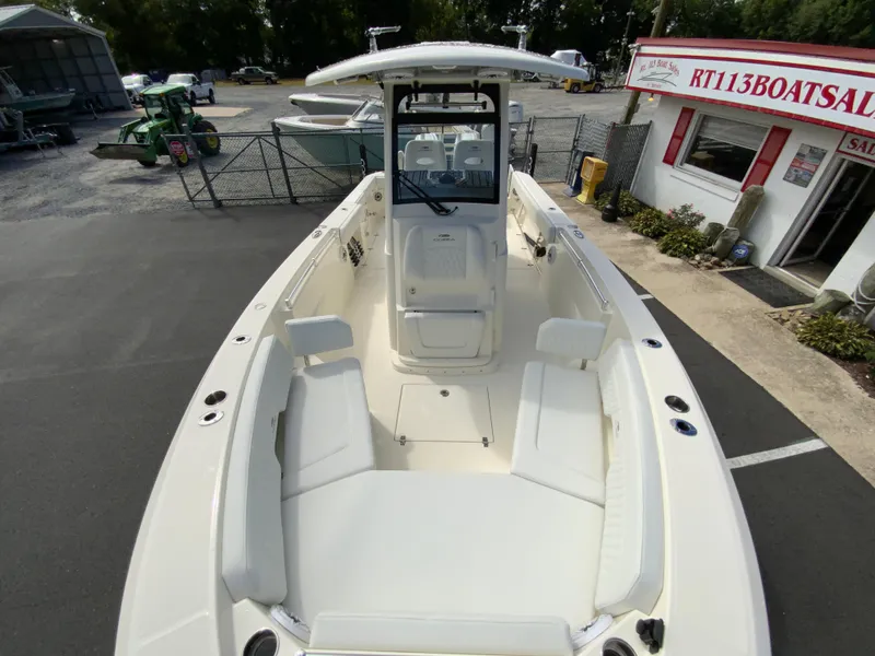 Slide: The Image of 2025 Cobia 265 Center Console Open boat at dealership, showcasing spacious seating and sleek design. - 33
