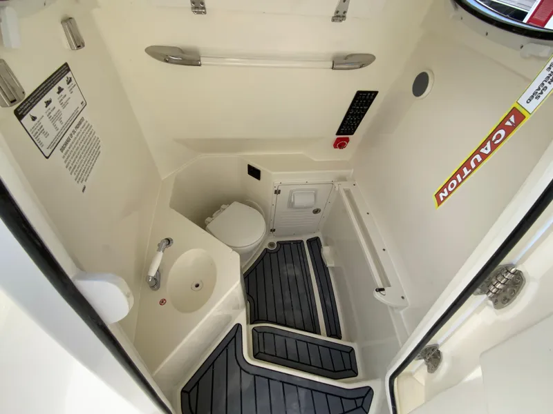 Slide: The Image of 2025 Cobia 265 Center Console Open boat interior with toilet and sink. - 37