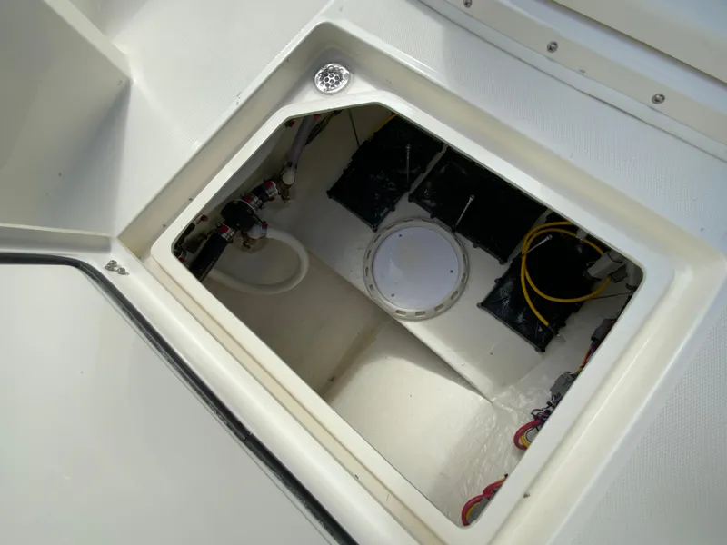 Slide: The Image of 2025 Cobia 265 Center Console Open storage compartment with wiring and equipment. - 39
