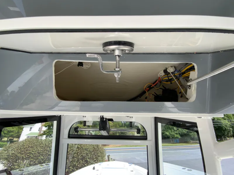 Slide: The Image of 2025 Cobia 265 Center Console Open boat interior storage compartment with wiring. - 42