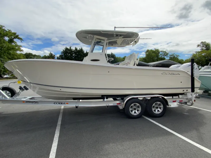 Slide: The Image of 2025 Cobia 265 Center Console Open boat on trailer in parking lot. - 5