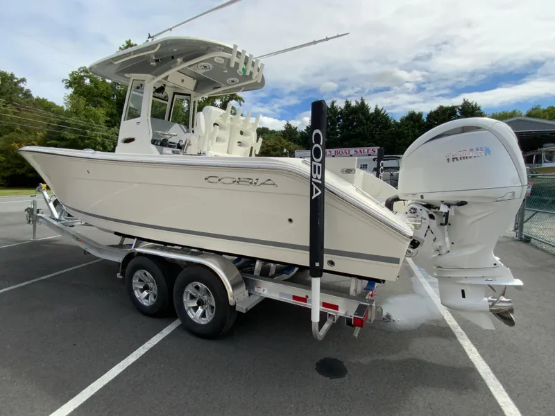 Slide: The Image of 2025 Cobia 265 Center Console Open boat on trailer, parked outdoors. - 6