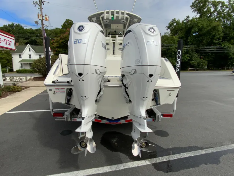Slide: The Image of 2025 Cobia 265 Center Console Open with dual outboard engines, rear view. - 8