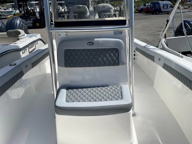 Slide: The Image of 2025 Defiance 240 Catalina boat interior with cushioned seating and sleek design. - 10