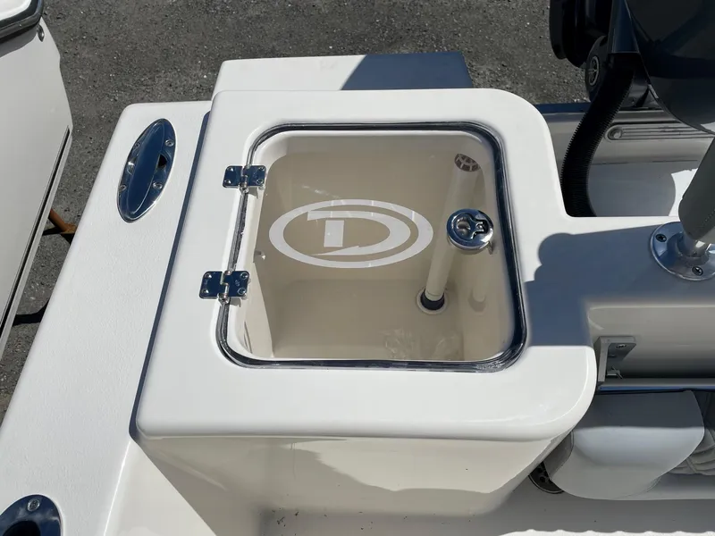 Slide: The Image of Defiance 240 Catalina 2025 boat livewell with logo, open lid, and clean design. - 2