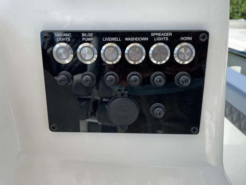 Slide: The Image of Control panel of 2025 Defiance 240 Catalina boat with labeled switches. - 4