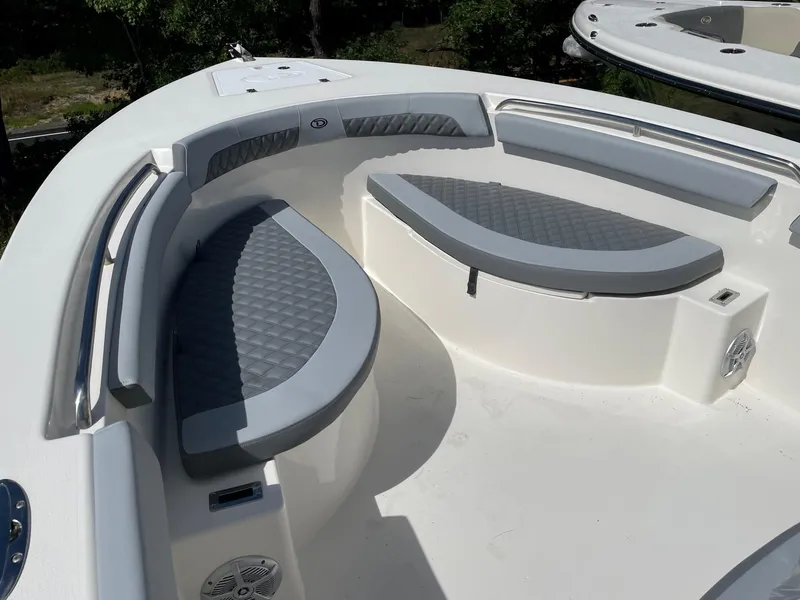 Slide: The Image of 2025 Defiance 240 Catalina boat with cushioned seating and sleek design. - 7