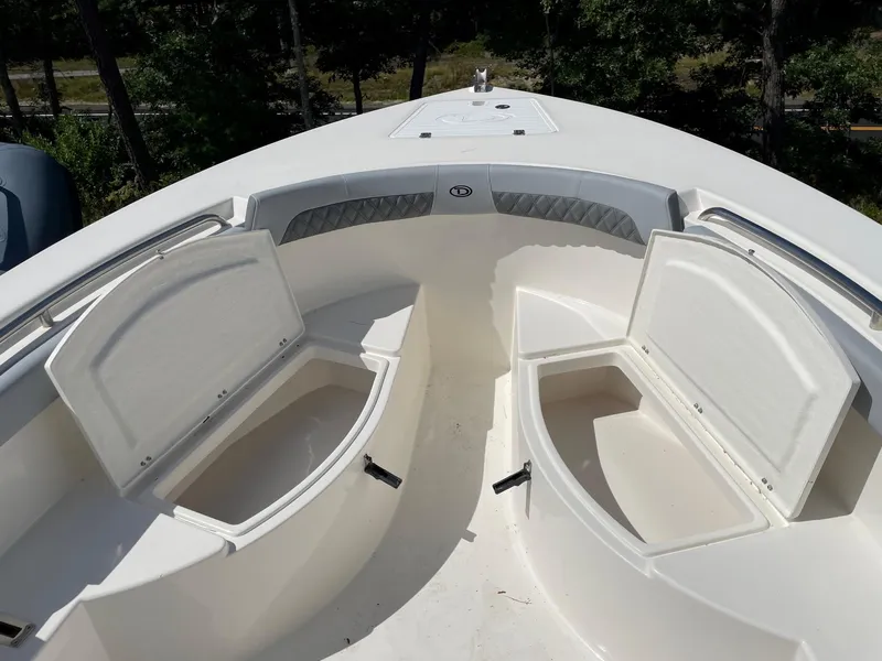 Slide: The Image of 2025 Defiance 240 Catalina boat with open storage compartments on deck. - 9