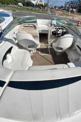 Slide: The Image of 2002 Chaparral 220 SSi boat interior with white seating and dashboard view. - 12