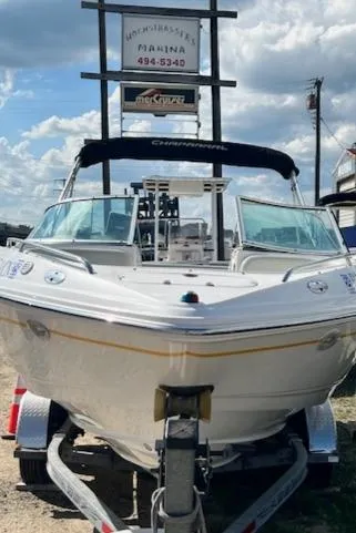 Slide: The Image of 2002 Chaparral 220 SSi boat on trailer at marina, under cloudy sky. - 2