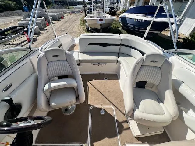 Slide: The Image of 2002 Chaparral 220 SSi boat interior with white seating and steering wheel. - 8