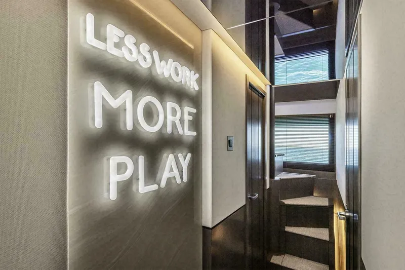 Slide: The Image of Modern yacht interior with "Less Work More Play" neon sign, Pearl 72, 2025 model. - 11