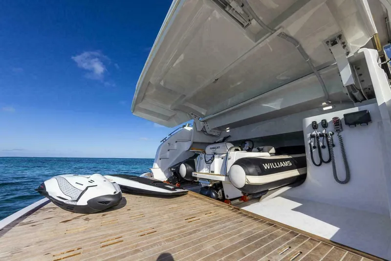 Slide: The Image of Luxury yacht Pearl 72 with open garage, showcasing watercraft and ocean view. - 25