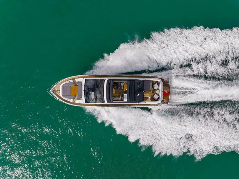Slide: The Image of Aerial view of 2025 Pearl 72 yacht cruising on turquoise water. - 3