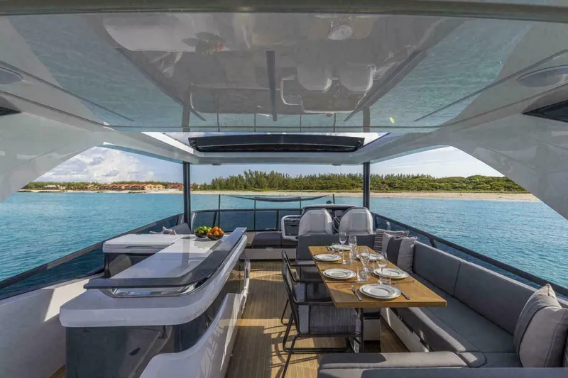 Slide: The Image of Luxurious 2025 Pearl 72 yacht interior with elegant dining area and scenic ocean view. - 33
