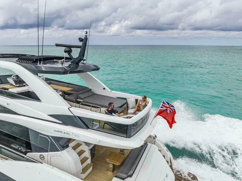 Slide: The Image of Luxury Pearl 72 yacht cruising on turquoise ocean, 2025 model, with two people relaxing on deck. - 5