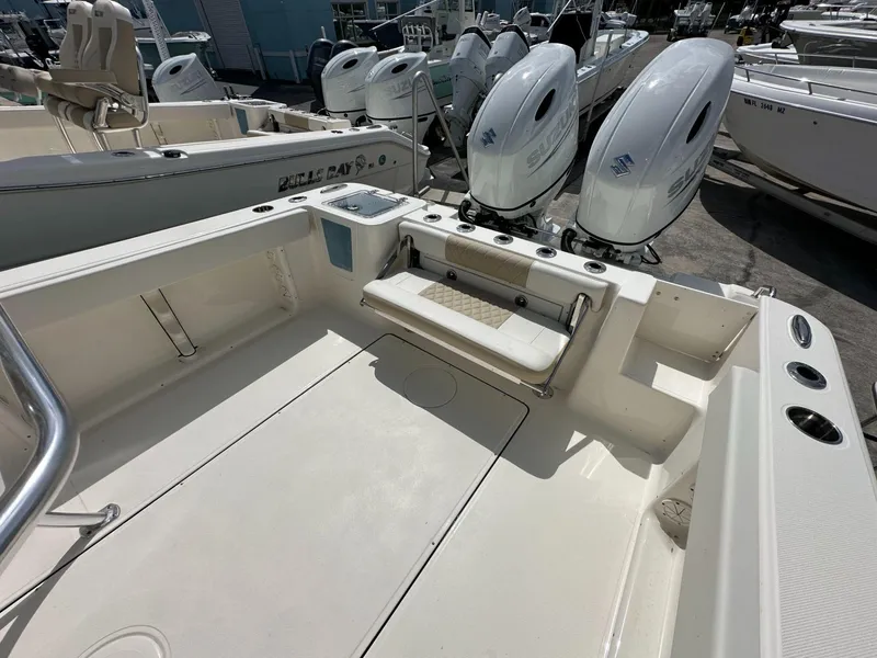 Slide: The Image of 2025 Bulls Bay 255 CC boat interior with dual Suzuki engines, spacious deck, and seating. - 10