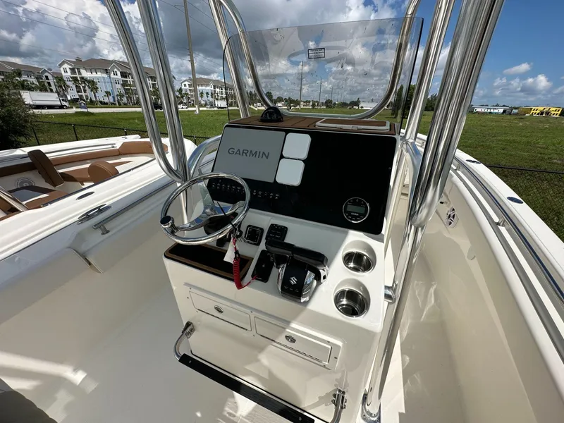Slide: The Image of 2025 Bulls Bay 255 CC boat console with Garmin navigation system and stainless steel steering wheel. - 4