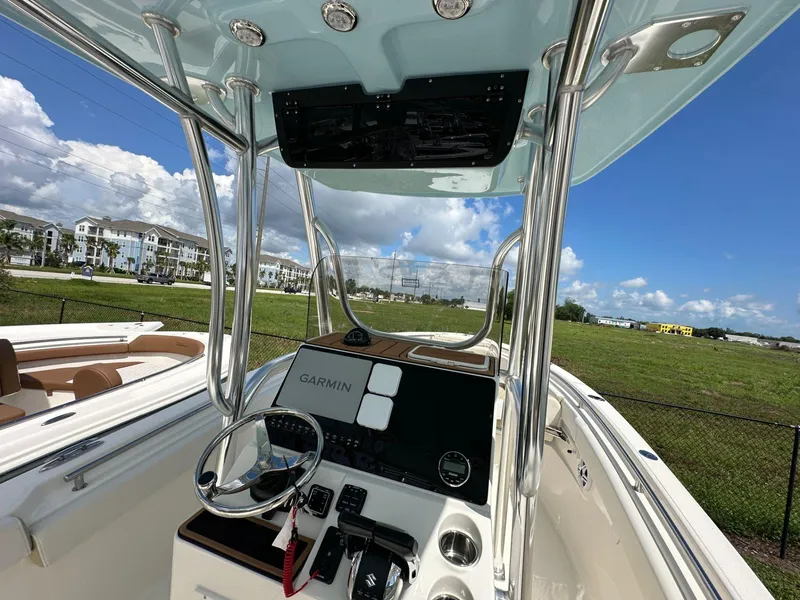 Slide: The Image of 2025 Bulls Bay 255 CC boat interior with Garmin navigation system, sunny day. - 5