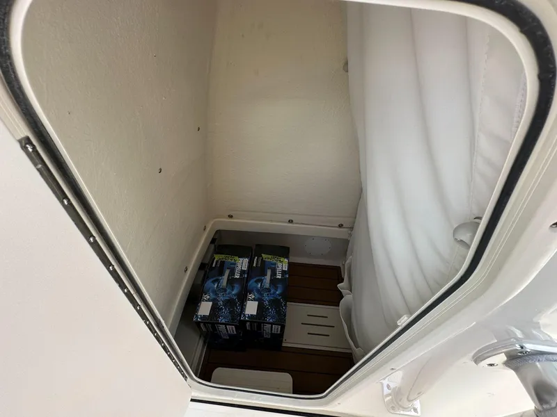 Slide: The Image of Storage compartment in 2025 Bulls Bay 255 CC boat with batteries and cushions. - 8